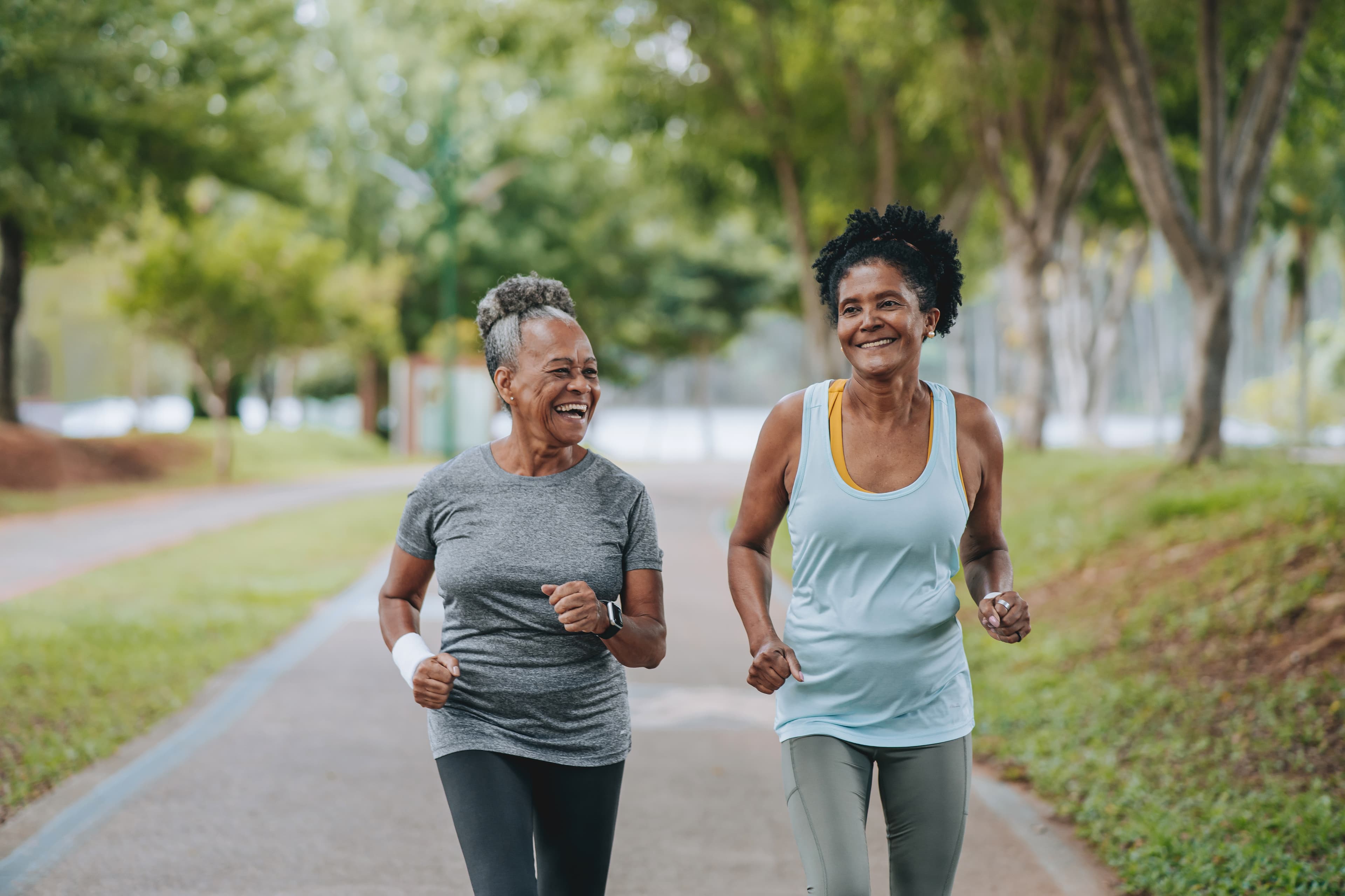 Two women jogging in park